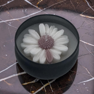 Matte black round bowl candle with white daisy on top